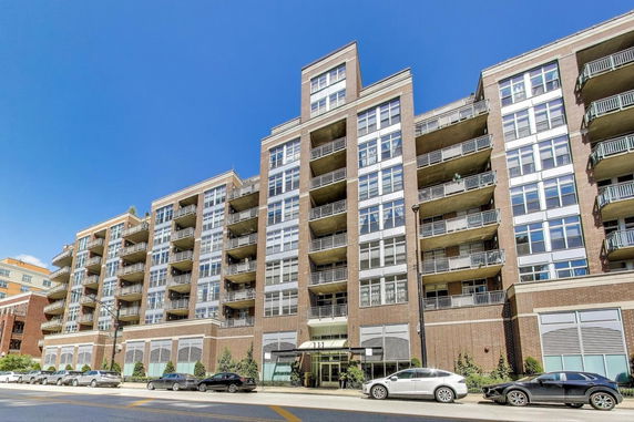 Front view of a multi-story residential building with balconies.