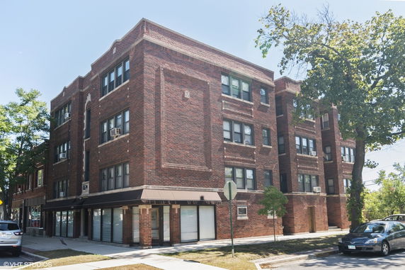 Front view of a multi-story brick apartment building.