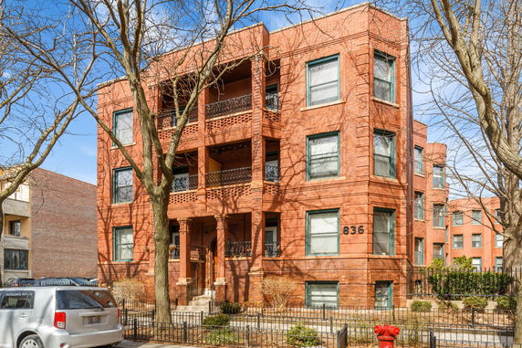 Front view of a three-story brick apartment building.