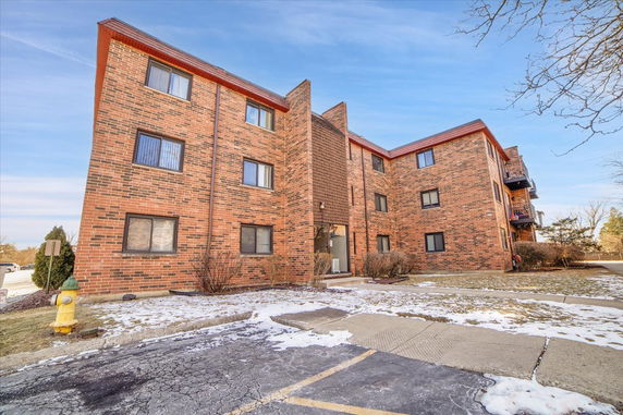Front view of a three-story brick apartment building.