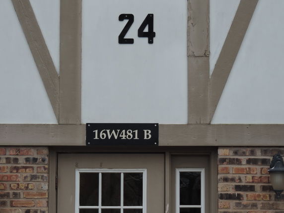 Front view of a building with exposed wooden beams and brickwork.