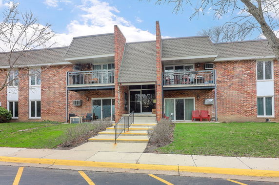 Front view of a two-story brick building with balconies.