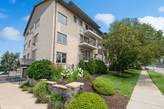 Front view of a multi-story residential building with balconies.