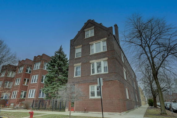 Front view of a three-story brick apartment building.