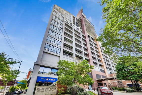 Front view of a multi-story building with large windows and balconies.