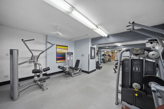 Interior view of a gym area with exercise equipment.