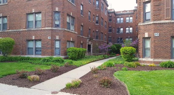 Front view of a multi-story brick apartment complex.