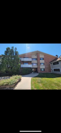 Front view of a three-story residential building with balconies.