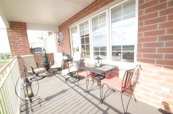 Outdoor balcony with seating area and a view of the surroundings.