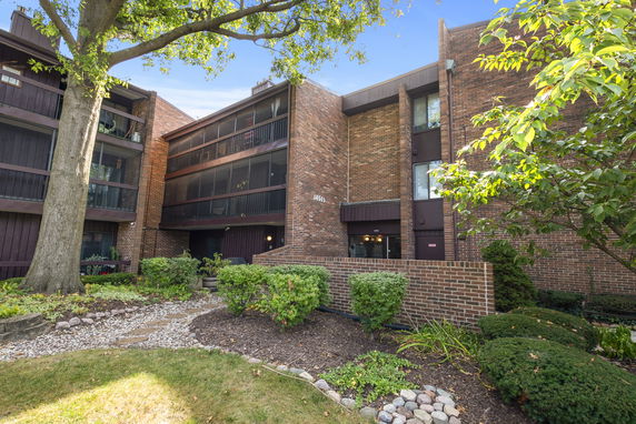 Front view of a multi-story brick building with balconies.