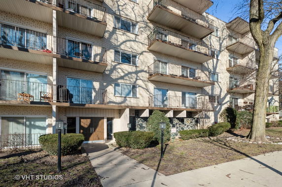 Front view of a multi-story residential building with balconies