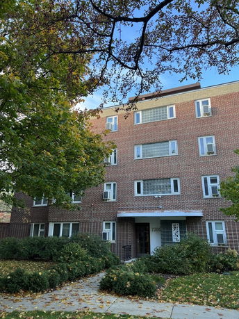 Front view of a multi-story brick apartment building.