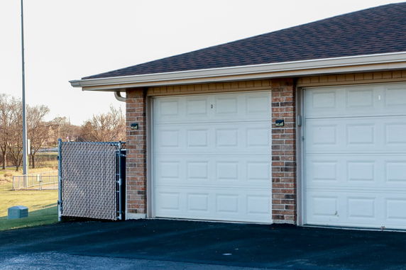 Front view of a brick building with a double garage.