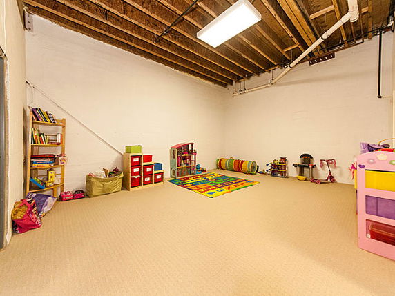 Indoor play area with toys and a play mat on the floor.
