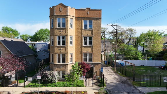 Front view of a multi-story brick apartment building.
