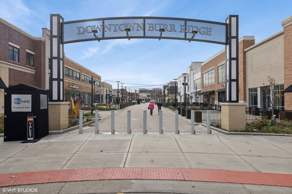 Front view of a commercial street with shops in a downtown area.