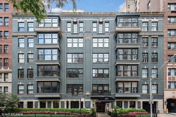Front view of a multi-story building with large windows and ornate details.