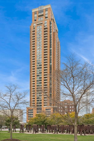 Front view of a tall multi-story building with balconies.