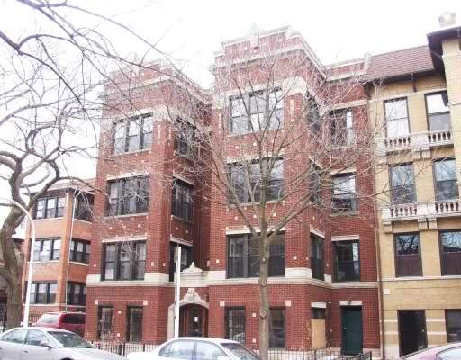 Front view of a multi-story brick apartment building.