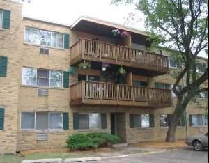 Front view of a three-story apartment building with balconies.