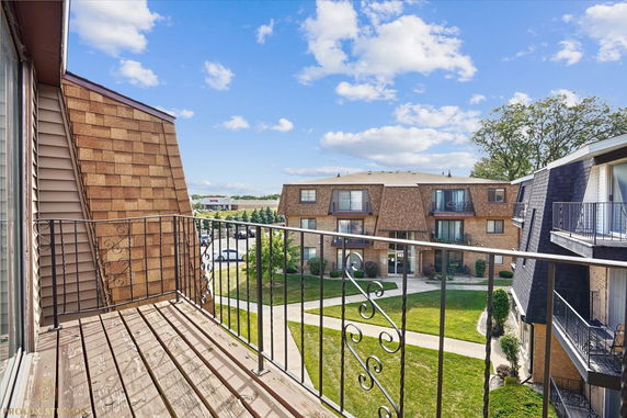 View from a balcony overlooking multi-story apartment buildings.