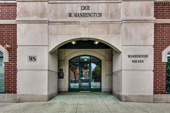 Front view of a building entrance with brick and stone facade.