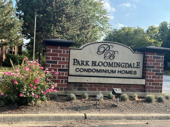 Entrance sign for Park Bloomingdale Condominium Homes with brick and stone design.