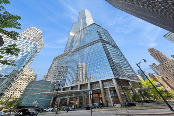 Front view of a tall glass skyscraper.