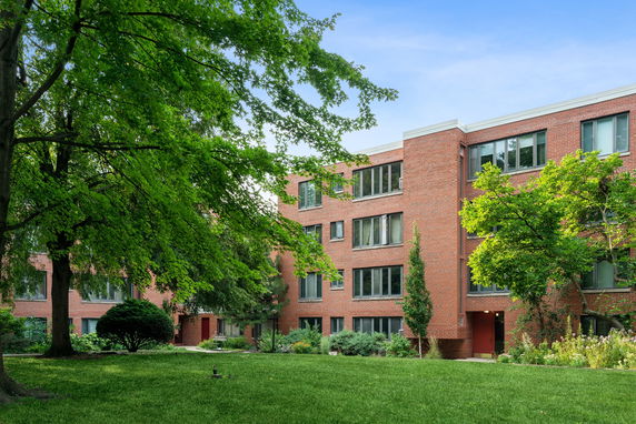 Front view of a multi-story brick apartment building.