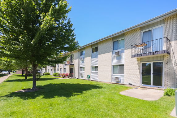 Front view of a two-story apartment building with balconies.