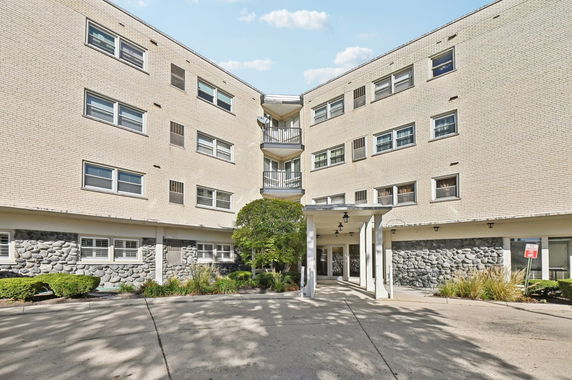 Front view of a multi-story building with a covered entrance.