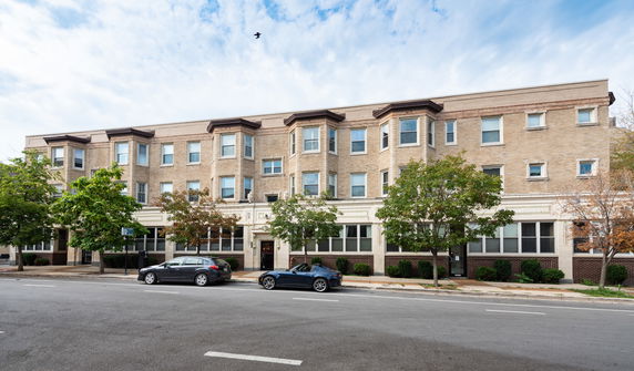 Front view of a three-story brick apartment building.