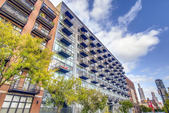 View of a modern multi-story apartment building with balconies.