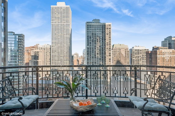 Panoramic view of city buildings from a balcony.