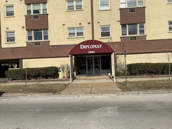 Front view of a multi-story building with an entrance named 'Diplomat' and address '7840'.