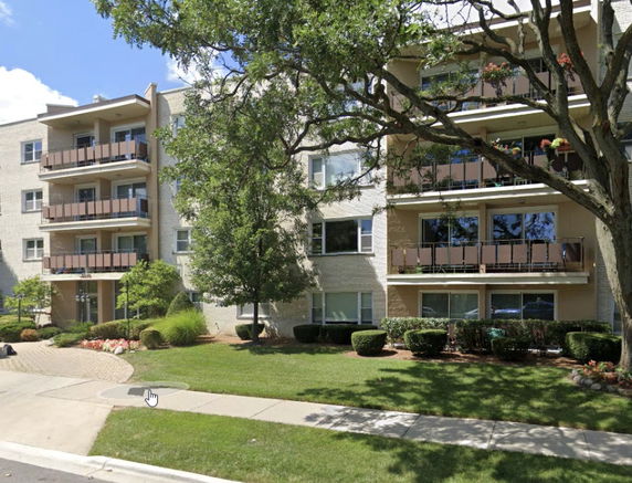 Front view of a multi-story residential building with balconies.