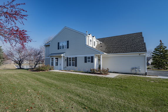 Front view of a two-story house with a gabled roof and attached garage.