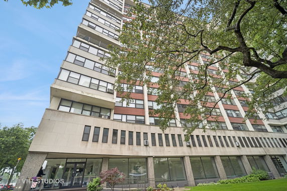 Front view of a high-rise building with multiple floors and large windows.