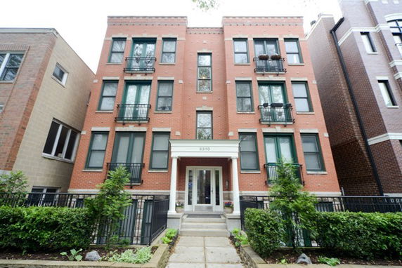 Front view of a multi-story brick apartment building.