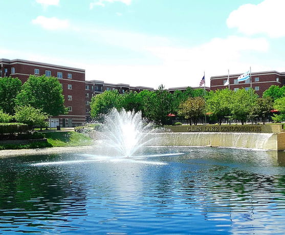 Front view of a multi-story building facing a fountain.