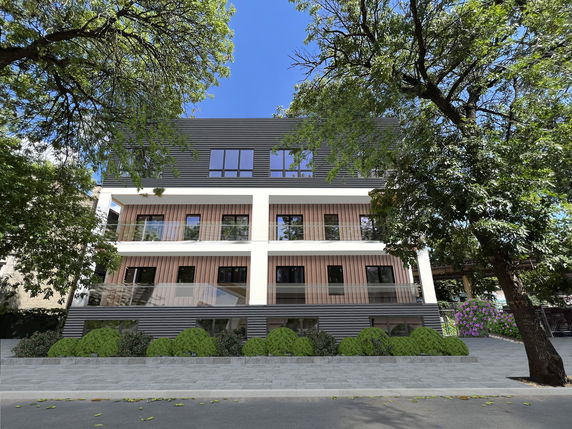 Front view of a modern three-story building with glass balconies.