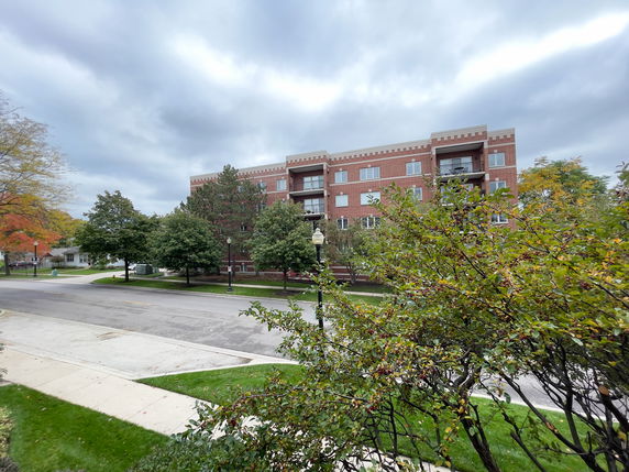 Front view of a multi-story brick apartment building.