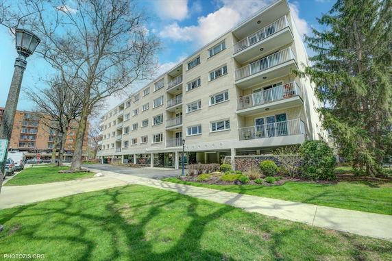 Front view of a multi-story apartment building with balconies.