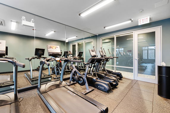 Indoor gym area with treadmills and exercise equipment.