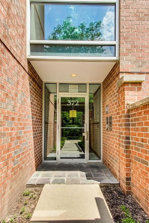 Front view of a modern brick building entrance with glass doors.