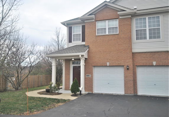 Front view of a two-story house with a double garage and brick exterior.