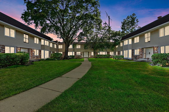 Front view of a two-story residential building with multiple entrances.
