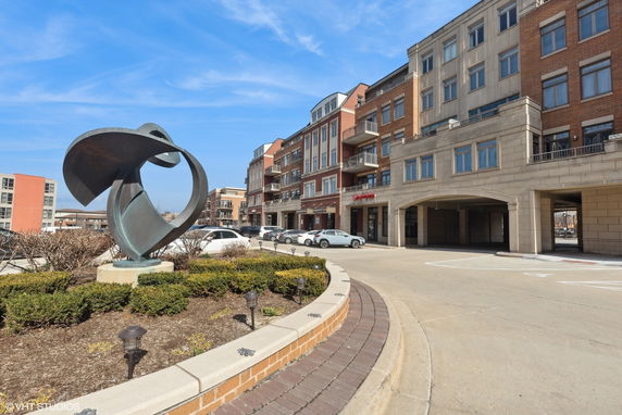 Front view of a multi-story building with commercial and residential units.