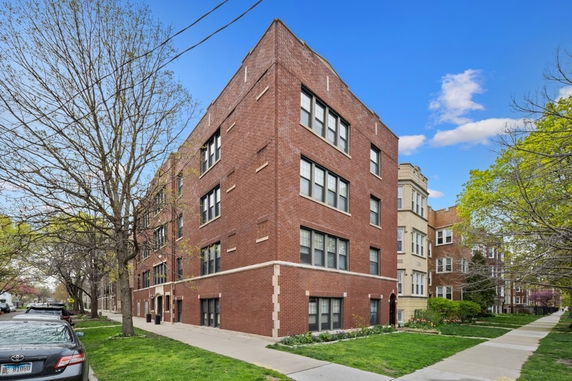 Front view of a multi-story brick apartment building.