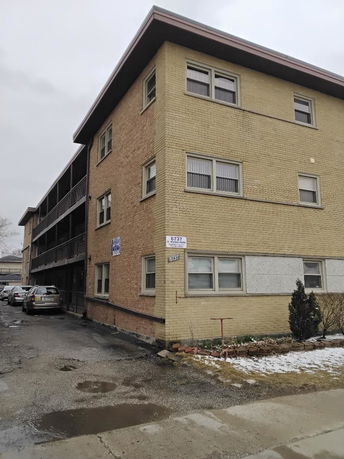 Front view of a three-story brick building.